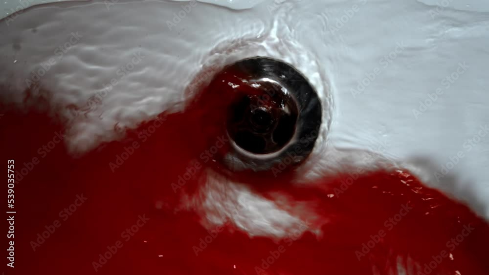 Blood with water flows down the drain hole in the shower. Concept blood, blood pressure, pool of blood on the shower.