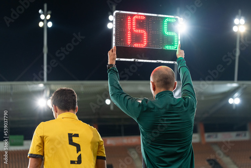 Obraz na płótnie Sideline referee shows players substitution during football match. w salonie