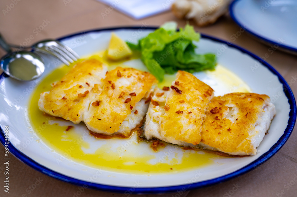 Grilled fillet of white codfish served in fish restaurant in San Sebastian, Basque Country, Spain Grilled fillet of white codfish served in fish restaurant in San Sebastian, Basque Country, Spain