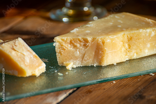 Italian cheese collection, piece of old parmigiano reggiano or parmesan cheese made from cow milk in Parma, Italy