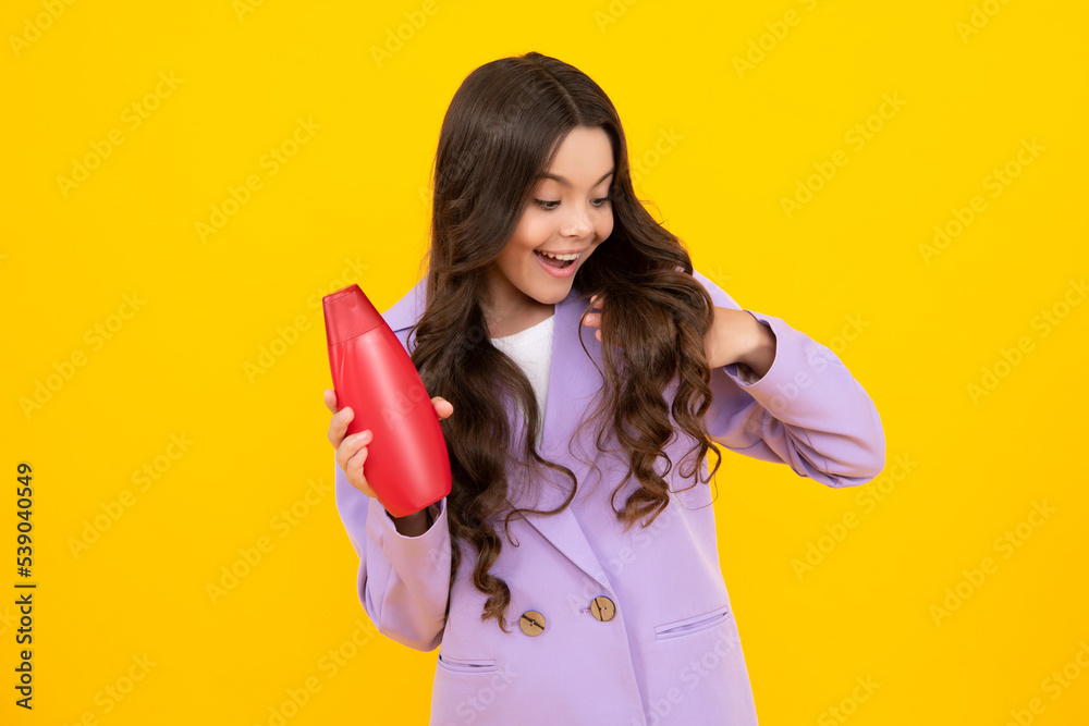 Teenage girl with shampoos conditioners or shower gel. Kids hair care cosmetic product, shampoo bottle. Happy teenager, positive and smiling emotions of teen girl. Teenage girl with shampoos conditioners or shower gel. Kids hair care cosmetic product, shampoo bottle. Happy teenager, positive and smiling emotions of teen girl.