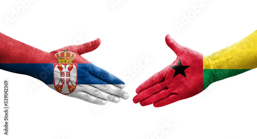 Handshake between Guinea Bissau and Serbia flags painted on hands, isolated transparent image.