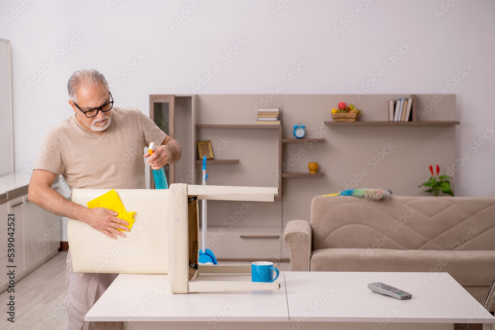 Old man doing housework at home Old man doing housework at home