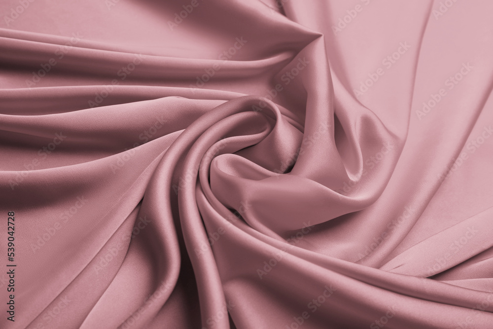 Obraz premium Delicate pink silk fabric as background, closeup view