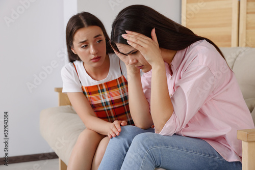 Professional psychologist working with young woman in office