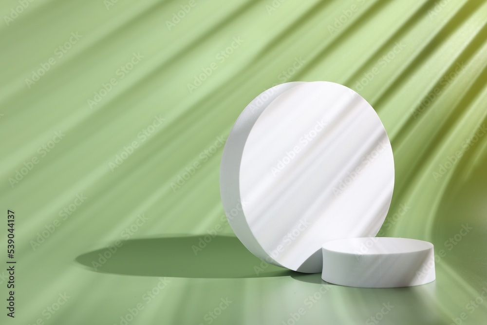 Scene with podium for product presentation. Round figures on pale light green background, space for text Scene with podium for product presentation. Round figures on pale light green background, space for text