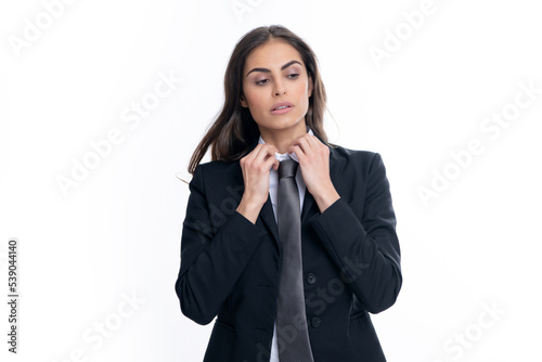Business woman in suit and tie. Confident female entrepreneur. Businesswoman correct necktie, prepare for business meeting. Portrait of attractive elegant fixing suit isolated on white background.