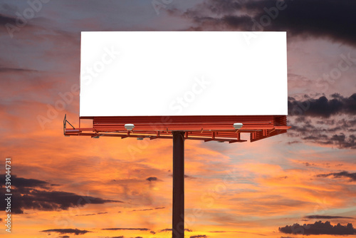 Foto Large blank billboard with cut out and orange sunset sky.