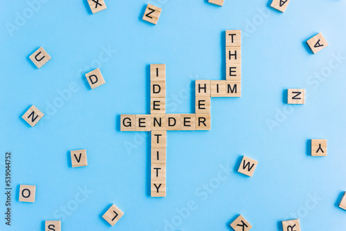 Words Gender Identity and His, Her and Them made up of wooden blocks with letters. Pronouns gender concept. photo