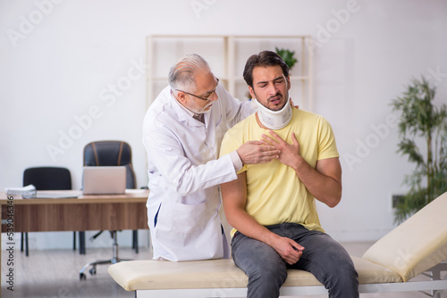 Young male neck injured patient visiting old male doctor