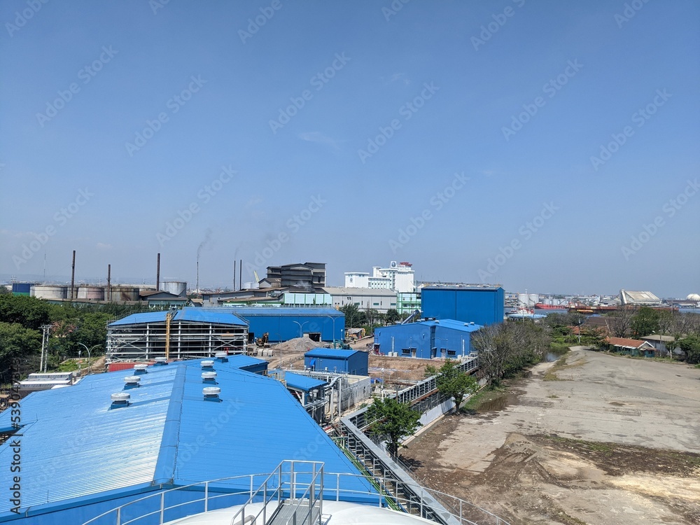 Landscape photo of power plant building with blue, orange and red sky. The photo is perfect for construction photo background, poster industry and pamphlet.