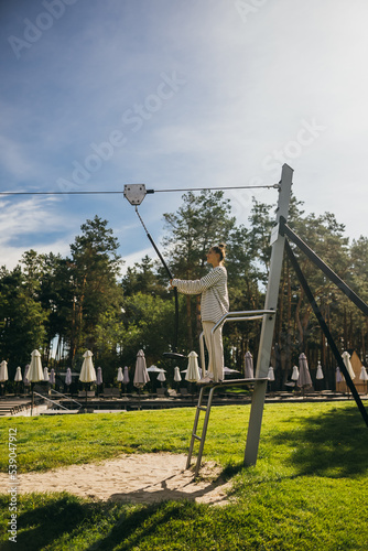 Woman wants to go bungee in the rope park