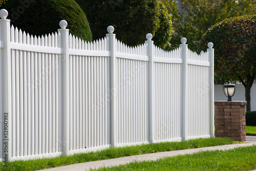 White vinyl fence in residential neighborhood