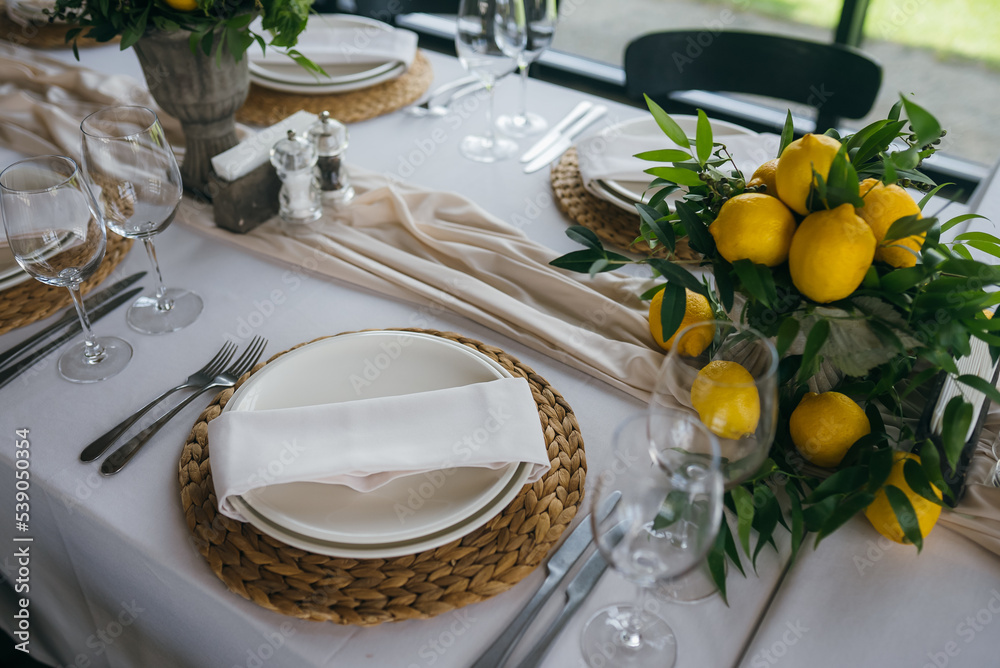 Festive table at the wedding party decorated with lemon arrangements