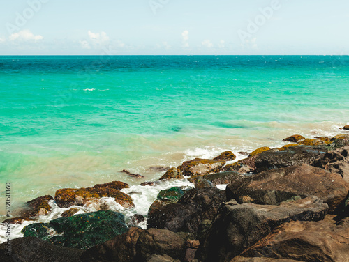 Beautiful beach bridge view from condado puerto rico with aqua and cristal waters and some rocks in the coast