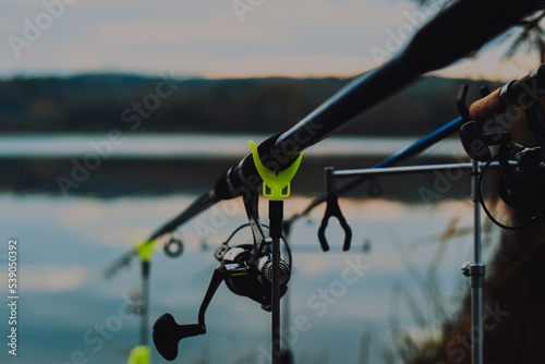 Sunrise or sunset fishing. Fishing rods on the background of the lake. Sports fishing. selective focus photo