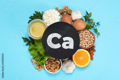 Food high in calcium. Flat lay composition with different products on light blue background photo