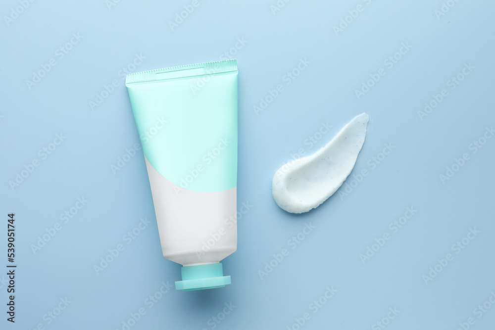 Sample of hand cream and tube on light blue background, top view Sample of hand cream and tube on light blue background, top view