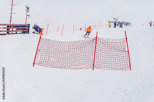 Winter, snowy day. Ski slope, practice slide, safety net for beginner skiers