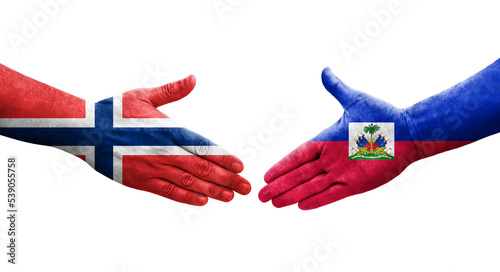 Handshake between Haiti and Norway flags painted on hands, isolated transparent image.