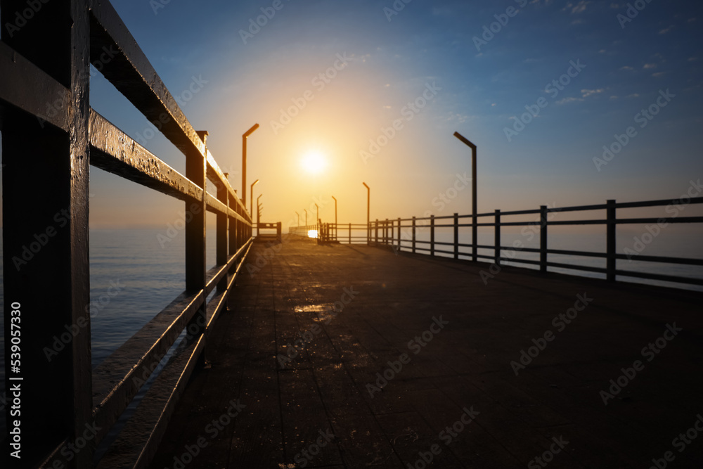 Picturesque view of empty pier at sunrise