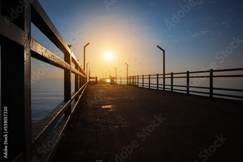Picturesque view of empty pier at sunrise