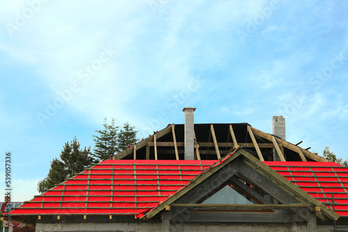 Roof of house under construction against sky
