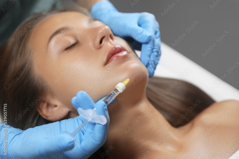 Beautiful woman getting facial injection in salon Beautiful woman getting facial injection in salon