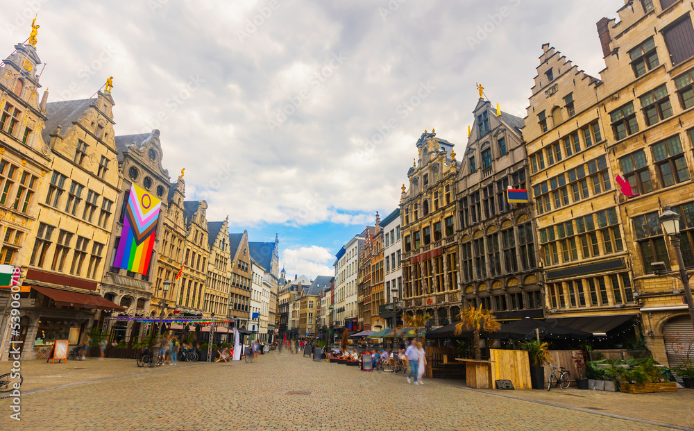 Market Square of Belgian city of Antwerp with big Pride flag on facade of one of ancient buildings at summer day