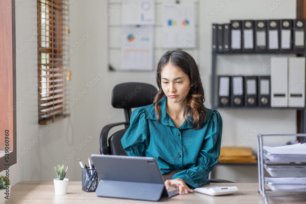 Asian business indian woman Accounting using calculating laptop income-expenditure and analyzing real estate investment data report Financial and tax systems in workplace an home office. Asian business indian woman Accounting using calculating laptop income-expenditure and analyzing real estate investment data report Financial and tax systems in workplace an home office.