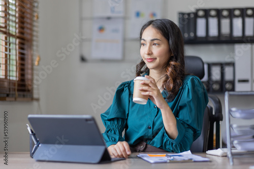 Wallpaper Mural Asian business indian woman Accounting using calculating laptop income-expenditure and analyzing real estate investment data report Financial and tax systems in workplace an home office.	 Torontodigital.ca