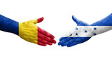 Handshake between Honduras and Romania flags painted on hands, isolated transparent image.