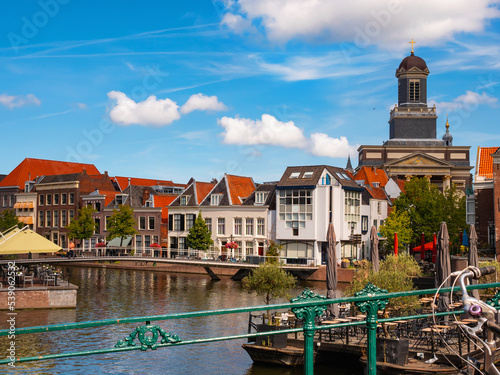 Streets along canal of Leiden with view of church. City in Province of South Holland, Netherlands. photo