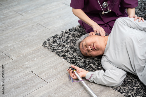 Elderly older mature female having an accident. Insurance health care. caregiver helping senior female from falling on the ground.