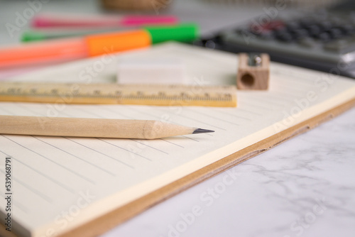 close up a pencil on paper with eraser ruler pencil sharpener on background (selective focus pencil) © piyaphunjun
