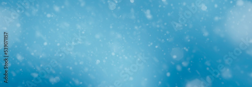 blue color blurred background with falling snow - for christmas use