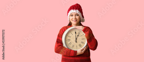 Young woman in Santa hat an...