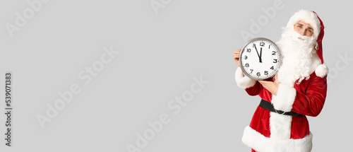 Santa Claus holding clock o...
