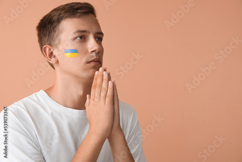 Young man with drawn flag o...