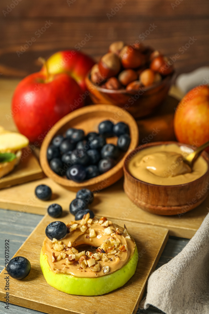 Tasty apple round with nut butter on table, closeup Tasty apple round with nut butter on table, closeup