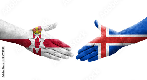 Handshake between Iceland and Northern Ireland flags painted on hands, isolated transparent image. photo