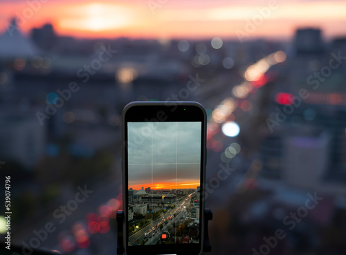 Astana, Kazakhstan, October, 2022. Shooting on the phone panoramas of the city. City buildings of the capital against the backdrop of the sunset.