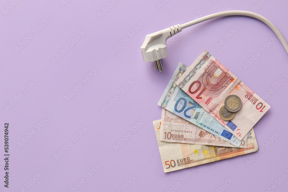 Money with plug on lilac background. Heating season concept Money with plug on lilac background. Heating season concept