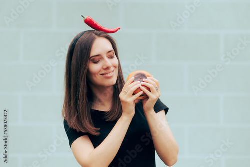 Obraz na płótnie Smiling Woman Enjoying a Tasty Spicey Hamburger