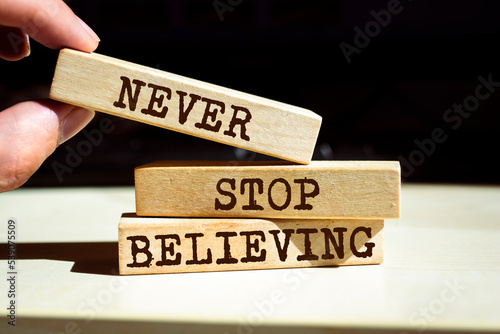 Wooden blocks with words 'Never Stop Believing'.