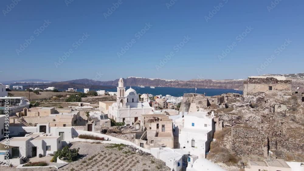 Aerial close flight towards greek church and Venetian Castle at Akrotiri village in Santorini, Greece Aerial close flight towards greek church and Venetian Castle at Akrotiri village in Santorini, Greece