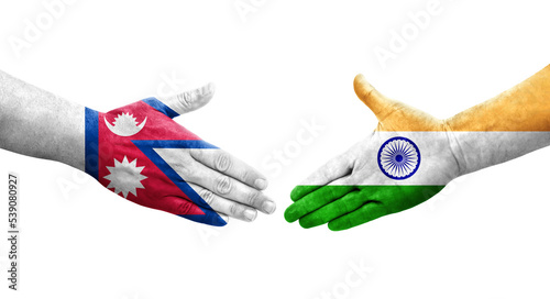 Handshake between India and Nepal flags painted on hands, isolated transparent image.