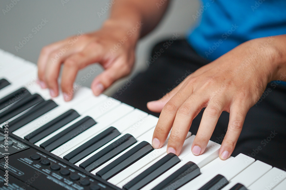 Close-up of male hands playing keyboard Close-up of male hands playing keyboard