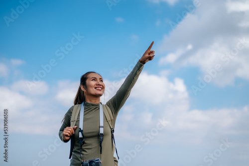 Young trekking female happy on rocky mountain peak