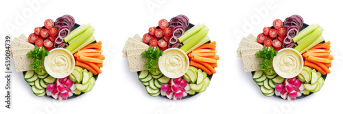 Healthy food plate with various raw vegetables, diet crispbreads and hummus, top view